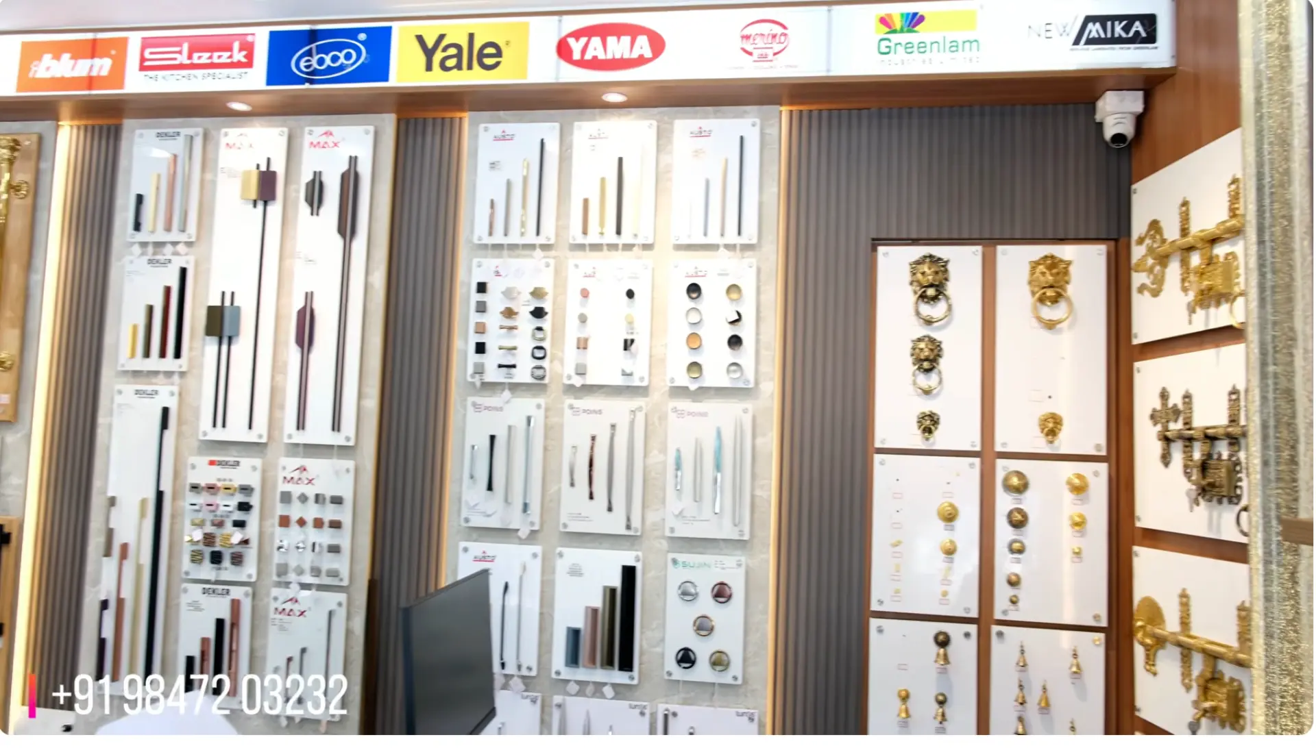 Sample boards of cabinet handles and knobs beneath brand signage at The Interior Mart