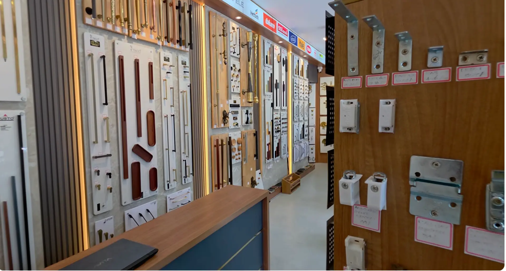 Display wall of designer door handles and pull bars inside The Interior Mart showroom in Trivandrum