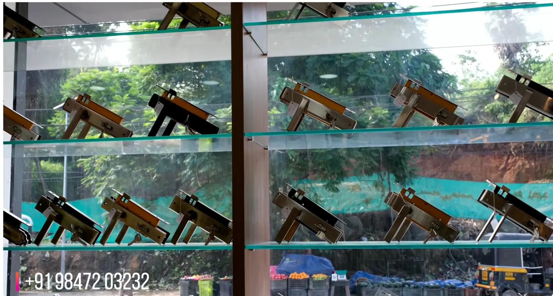 Glass shelving with mortise door locks on display at The Interior Mart, Thiruvananthapuram